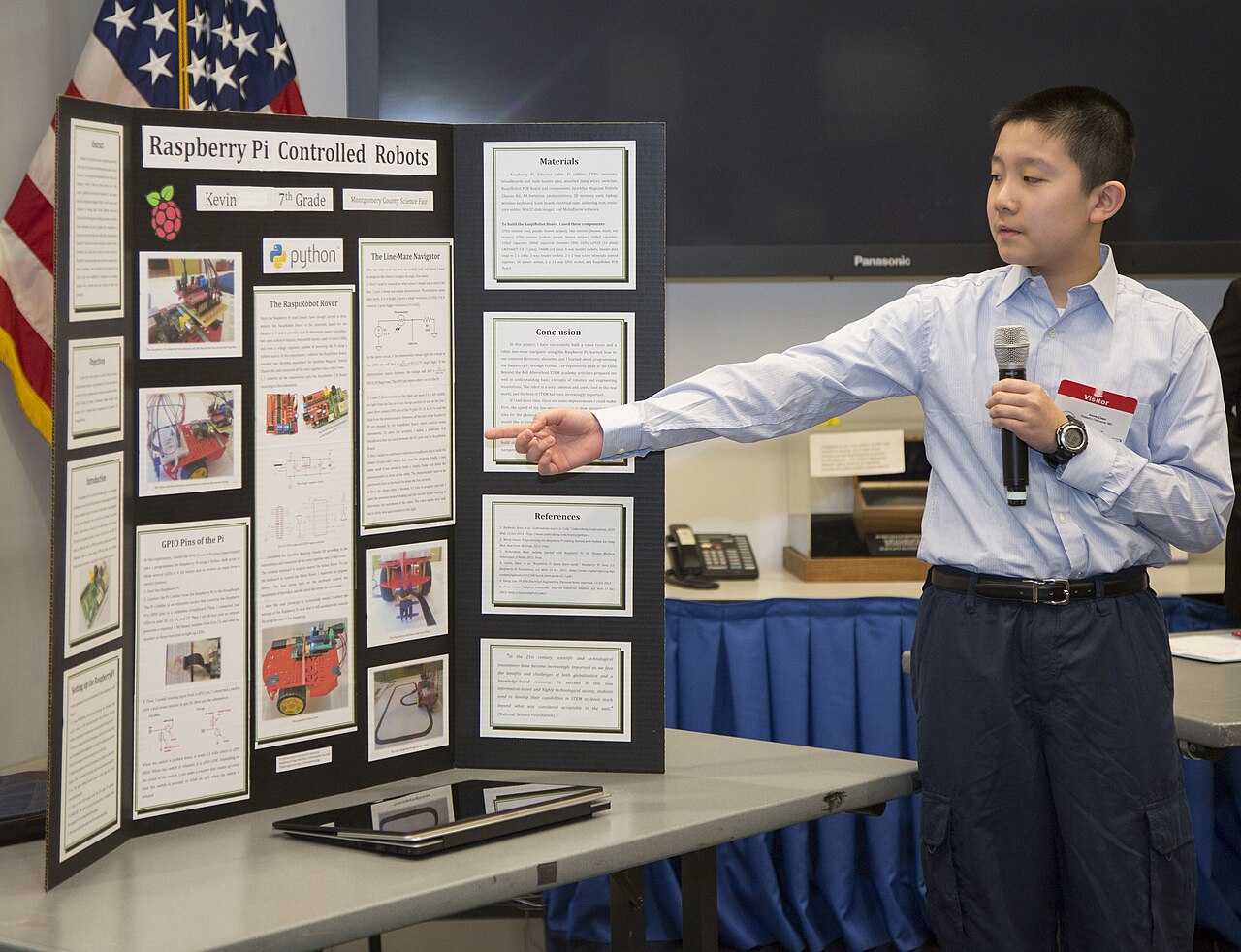 A student presenting a modern robotics project built with a Raspberry Pi